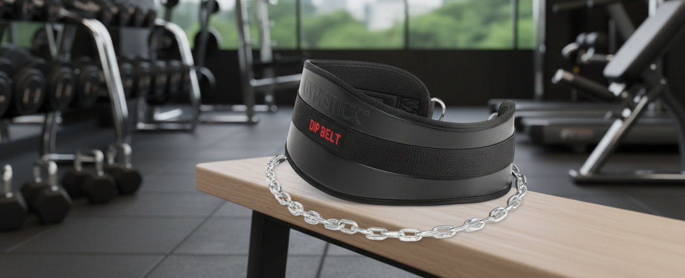 Black weightlifting belt on a wooden bench in a gym setting